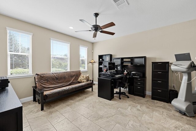 tiled home office featuring ceiling fan