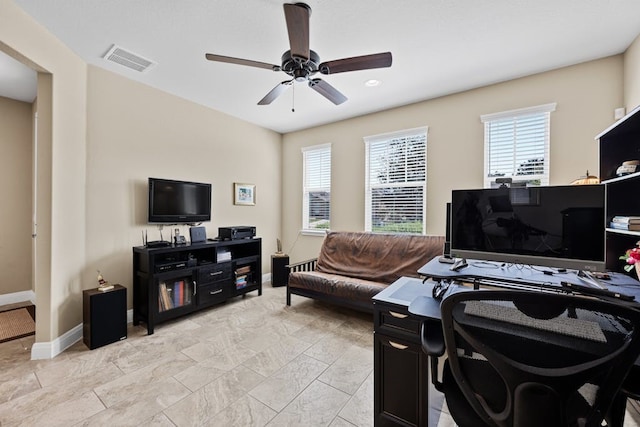 office space with baseboards, visible vents, and a ceiling fan