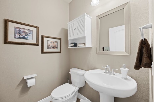 bathroom featuring sink and toilet