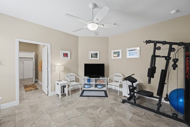 workout area with ceiling fan and light tile patterned floors