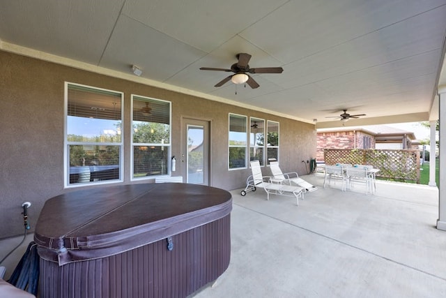 view of patio / terrace featuring ceiling fan and a hot tub