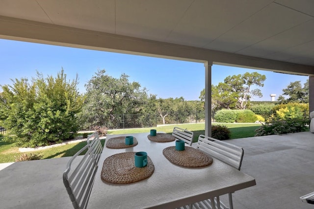 view of patio with outdoor dining area and fence