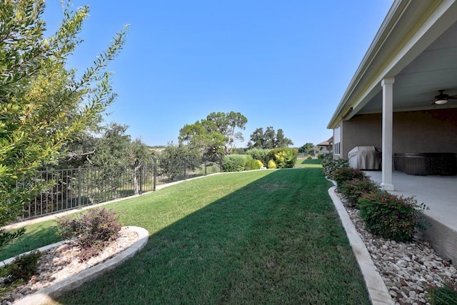 view of yard with a patio area, fence, and ceiling fan