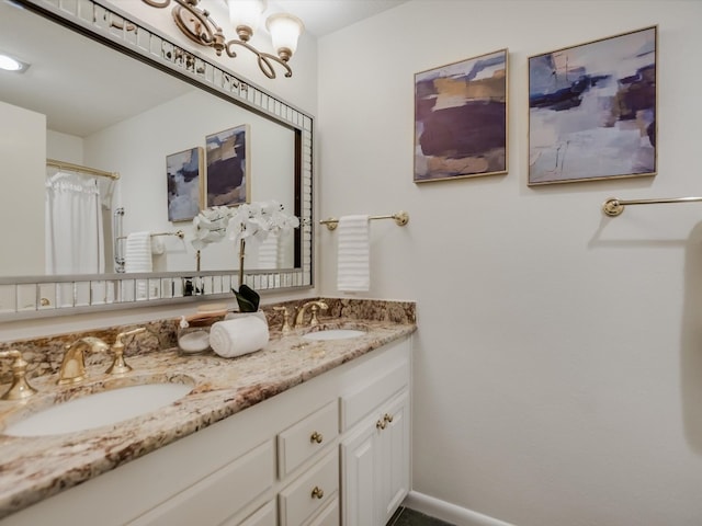 bathroom with vanity and a chandelier