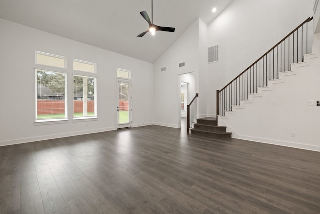 unfurnished living room featuring ceiling fan, dark wood-type flooring, and high vaulted ceiling