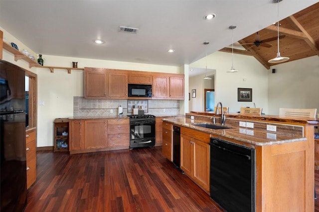 kitchen featuring a sink, visible vents, hanging light fixtures, light stone countertops, and black appliances