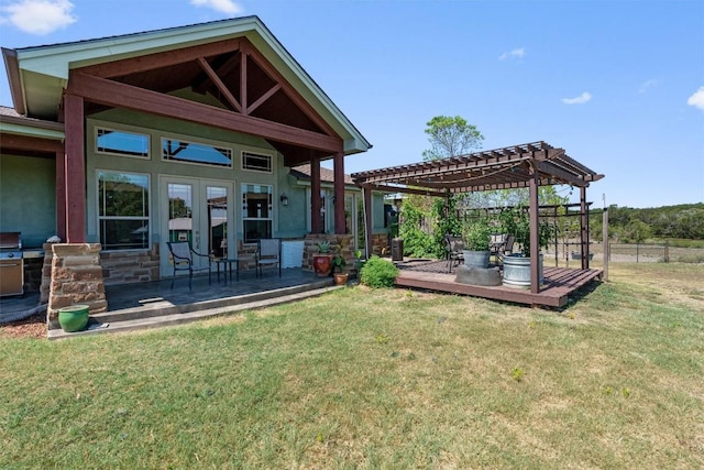 exterior space featuring french doors, a yard, fence, and a pergola