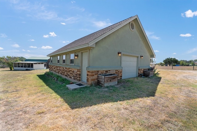 view of home's exterior featuring a garage and a lawn