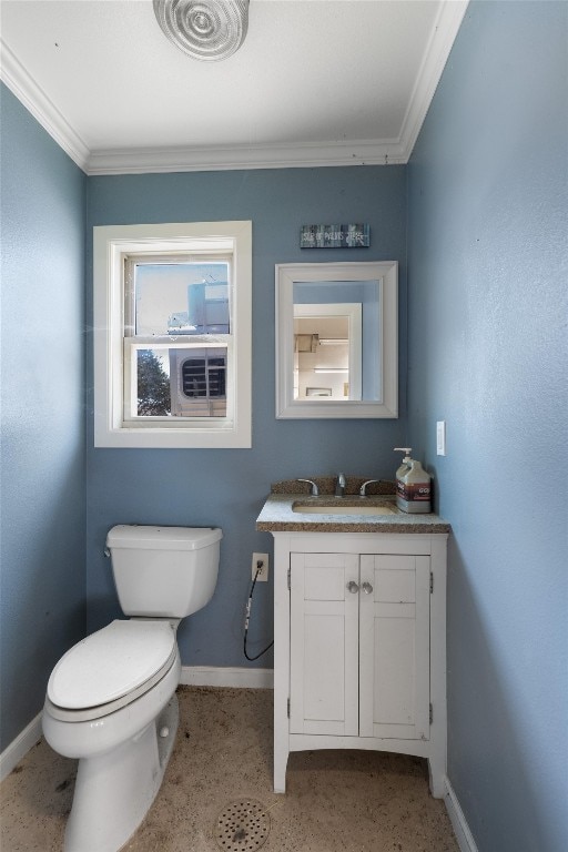 bathroom with toilet, baseboards, ornamental molding, and vanity