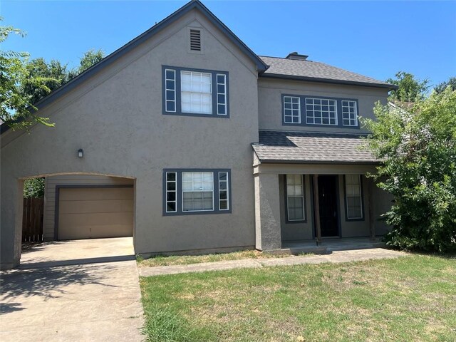 front of property with a garage and a front yard