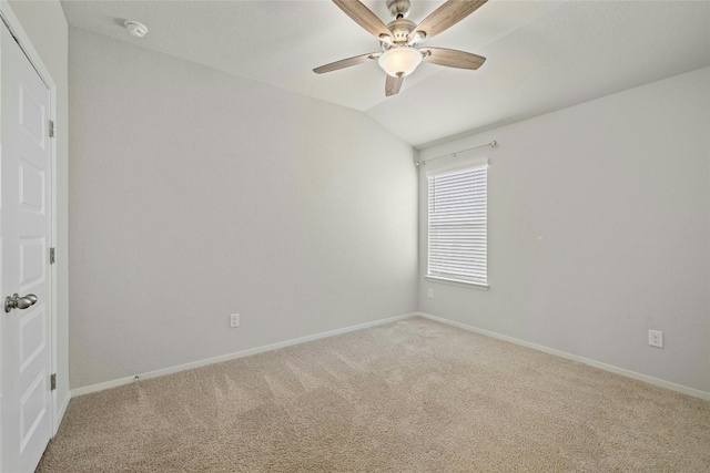 unfurnished room with carpet floors, ceiling fan, and vaulted ceiling