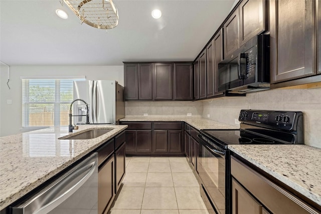 kitchen with decorative backsplash, black appliances, light stone counters, and light tile patterned floors