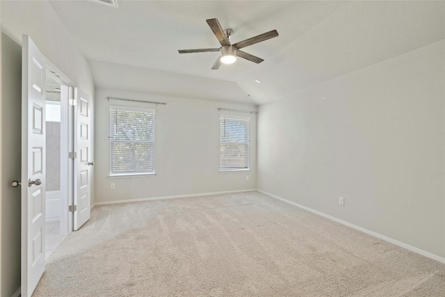 unfurnished room featuring ceiling fan, carpet, and lofted ceiling