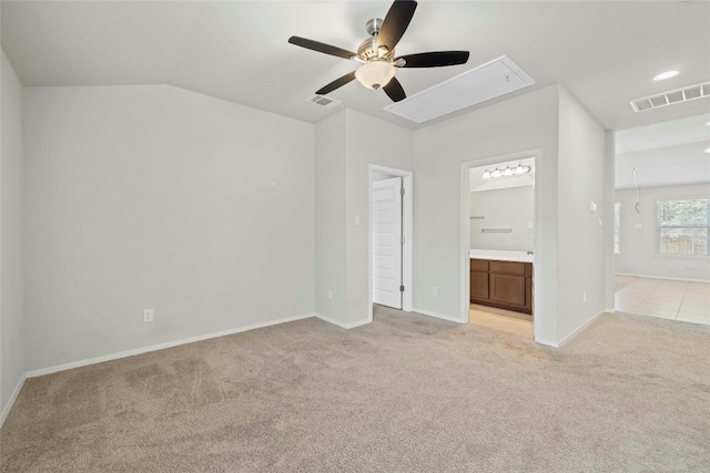 unfurnished bedroom with ceiling fan, light colored carpet, ensuite bathroom, and lofted ceiling