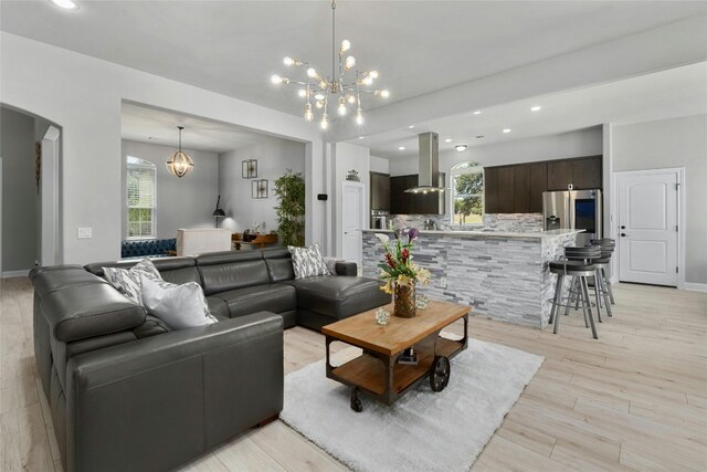 living room featuring light hardwood / wood-style floors and an inviting chandelier