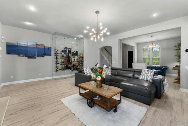 living room with light hardwood / wood-style flooring and a chandelier