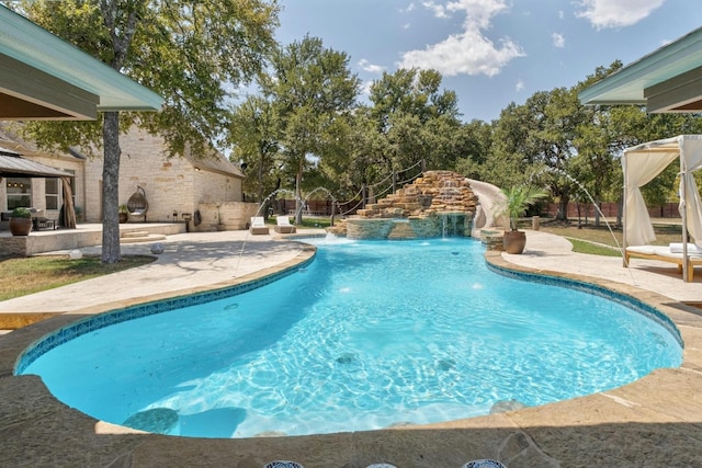 view of swimming pool with pool water feature and a patio