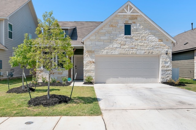 view of front of property featuring a garage and a front lawn