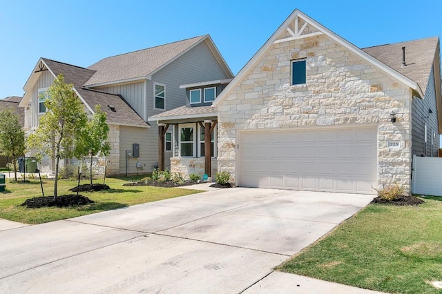 view of front facade featuring stone siding, concrete driveway, a shingled roof, and a front yard