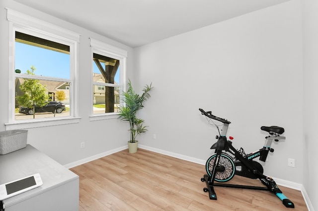 exercise area with light wood-type flooring