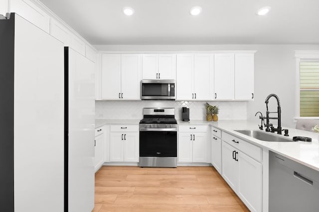 kitchen with white cabinets and appliances with stainless steel finishes