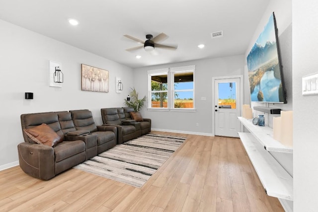 living room featuring ceiling fan and light hardwood / wood-style flooring