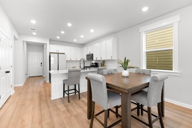 dining room with light hardwood / wood-style floors