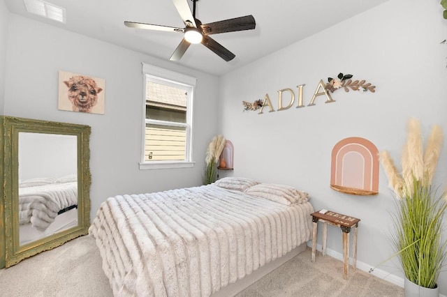 carpeted bedroom with a ceiling fan and baseboards