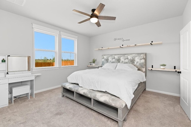carpeted bedroom with baseboards and a ceiling fan