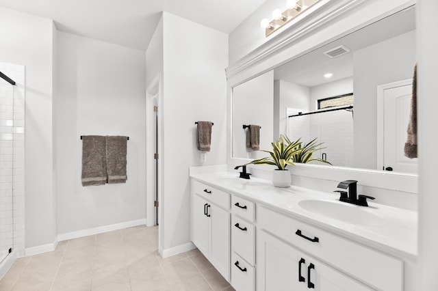 bathroom featuring tile patterned flooring, vanity, and a shower with door