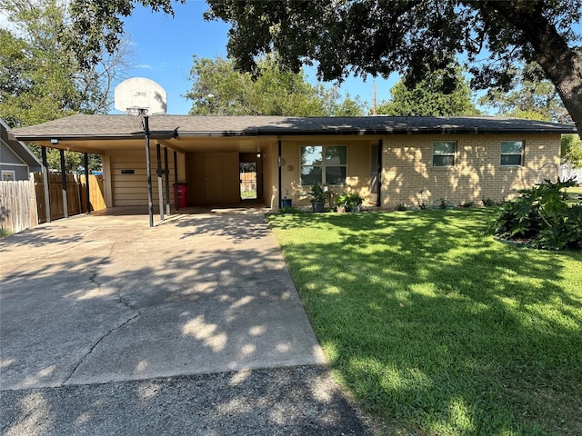 view of front facade with a front yard and a carport