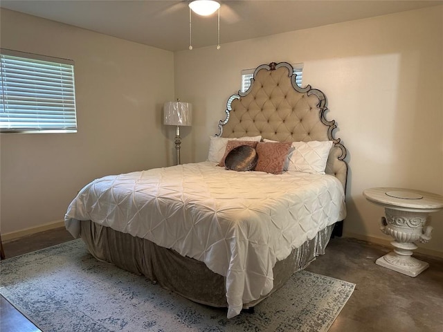 bedroom with baseboards and concrete flooring