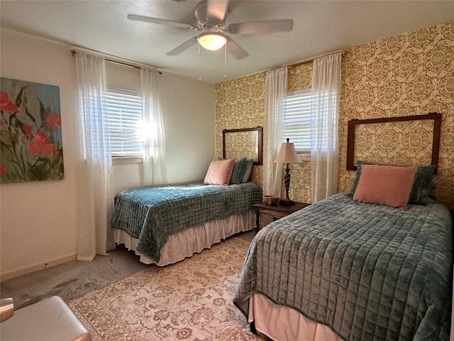 carpeted bedroom featuring ceiling fan, baseboards, and wallpapered walls