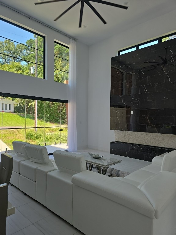 living room with ceiling fan and light tile patterned floors