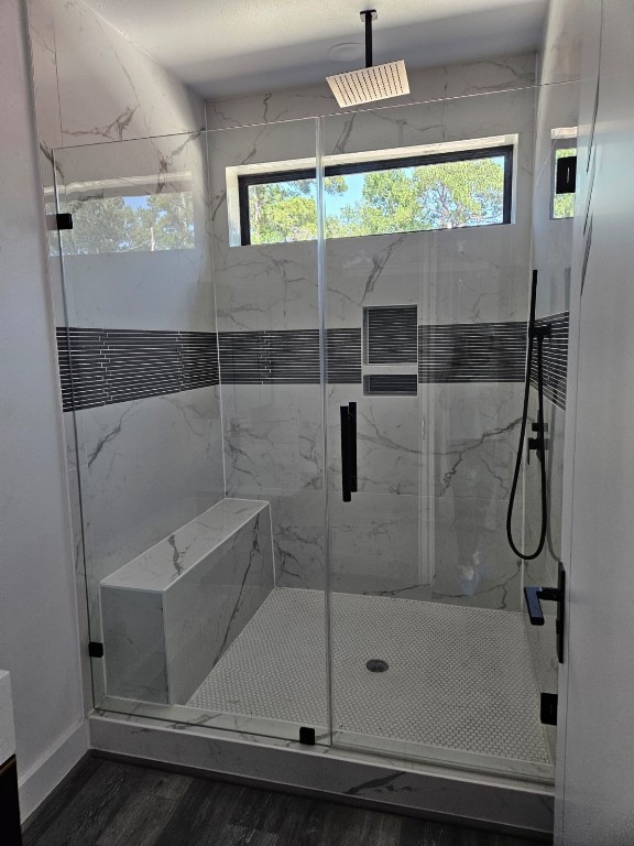 bathroom featuring an enclosed shower and hardwood / wood-style floors