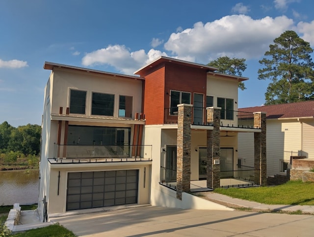 contemporary home featuring a balcony and a garage