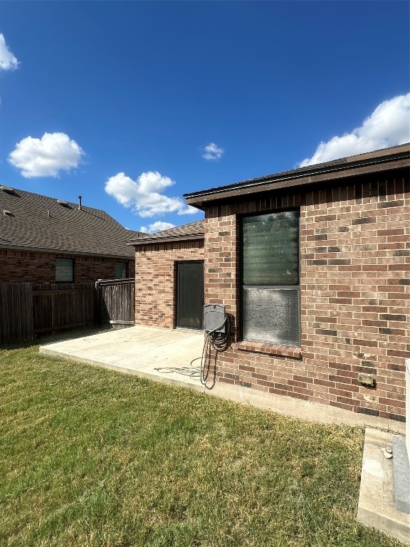 back of house featuring a patio and a lawn