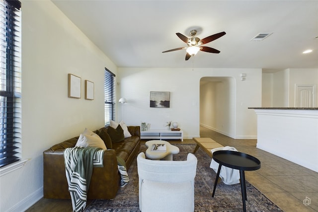 tiled living room featuring ceiling fan