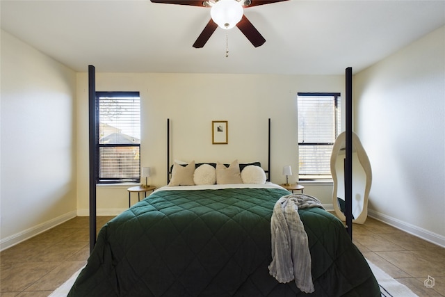 bedroom featuring multiple windows, ceiling fan, and light tile patterned flooring