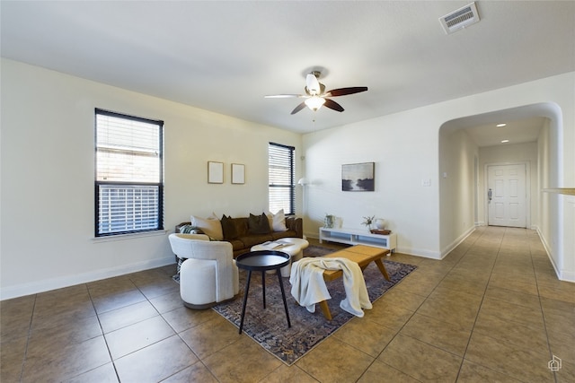 tiled living room with ceiling fan