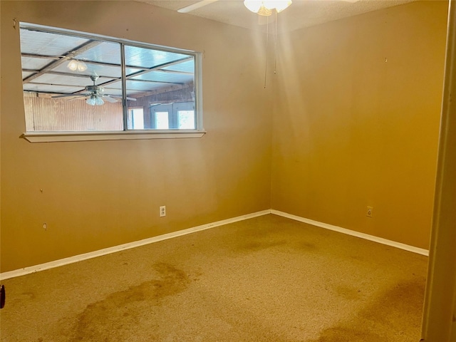 carpeted empty room featuring ceiling fan