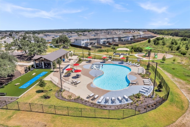 view of pool with a patio area and a lawn