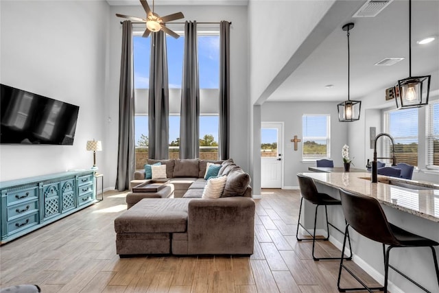 121 Woods Edge Ln, Georgetown, TX 78628 - living room with light wood-style flooring, a towering ceiling, and a ceiling fan