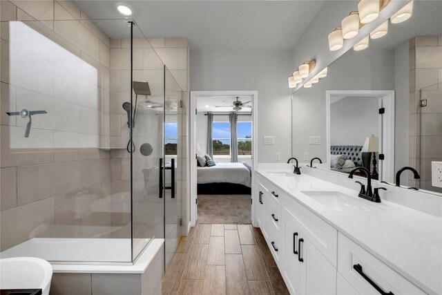 121 Woods Edge Ln, Georgetown, TX 78628 - bathroom with ensuite bath, a shower stall, ceiling fan, and double vanity