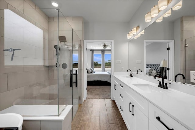 121 Woods Edge Ln, Georgetown, TX 78628 - ensuite bathroom with a stall shower, double vanity, and a ceiling fan
