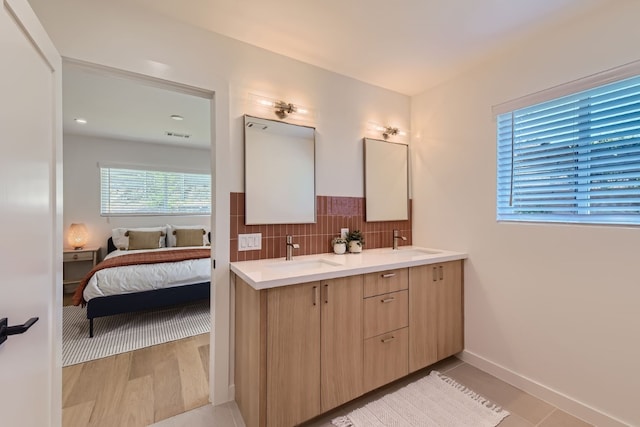 bathroom featuring decorative backsplash, vanity, and wood-type flooring