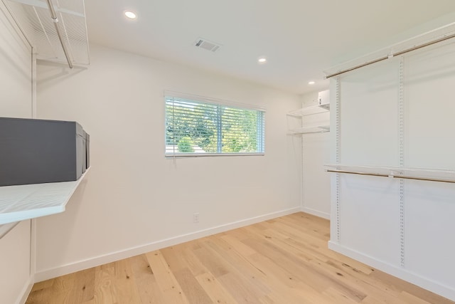 spacious closet with light hardwood / wood-style floors