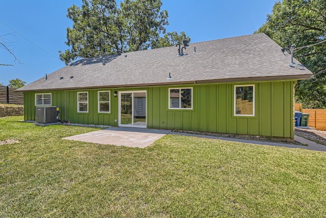 back of house with central AC, a patio area, and a yard