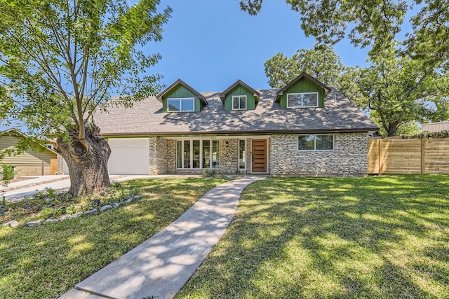 cape cod home with a front lawn and a garage