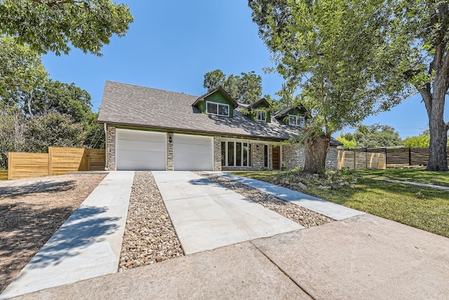 view of front of home with a garage and a front yard